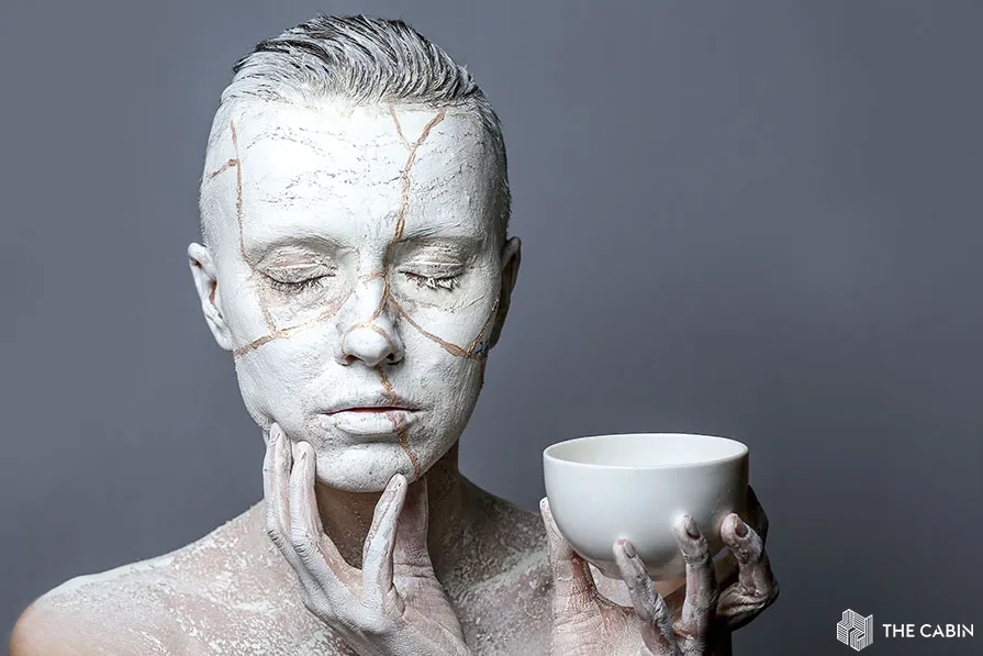 Art portrait of woman covered in clay